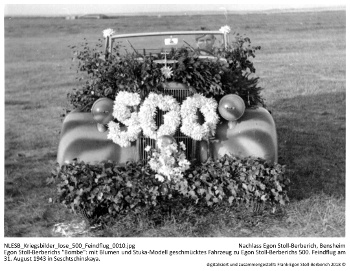 Egon Stoll-Berberichs "Bombe": mit Blumen und Stuka-Modell geschmücktes Fahrzeug zu Egon Stoll-Berberichs 500. Feindflug am 31. August 1943 in Seschtschinskaya. NLESB_Kriegsbilder_lose_500_Feindflug_0010. Egon Stoll-Berberichs "Bombe": mit Blumen und Stuka-Modell geschmücktes Fahrzeug zu Egon Stoll-Berberichs 500. Feindflug am 31. August 1943 in Seschtschinskaya. NLESB_Kriegsbilder_lose_500_Feindflug_0010.