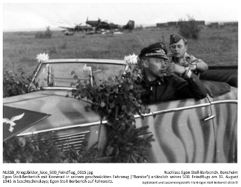 Egon Stoll-Berberich mit Kamerad in seinem geschmückten Fahrzeug ("Bombe") anlässlich seines 500. Feindflugs am 31. August 1943 in Seschtschinskaya; Egon Stoll-Berberich auf Fahrersitz. NLESB_Kriegsbilder_lose_500_Feindflug_0015. Egon Stoll-Berberich mit Kamerad in seinem geschmückten Fahrzeug ("Bombe") anlässlich seines 500. Feindflugs am 31. August 1943 in Seschtschinskaya; Egon Stoll-Berberich auf Fahrersitz. NLESB_Kriegsbilder_lose_500_Feindflug_0015.